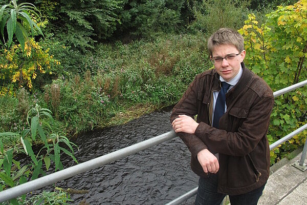 Councillor Jack Caldwell standing at the Water of Leith