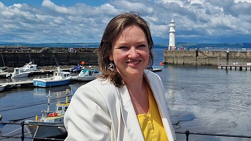 Sanne standing at Newhaven Harbour on a sunny day