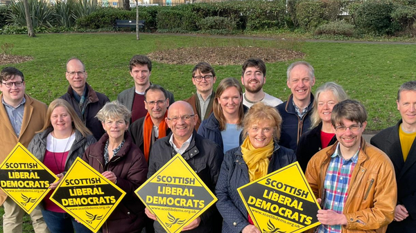 A group of people holding 'Scottish Liberal Democrat' diamonds