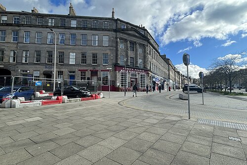 A picture of Elm Row with temporary barriers at Montgomery Street