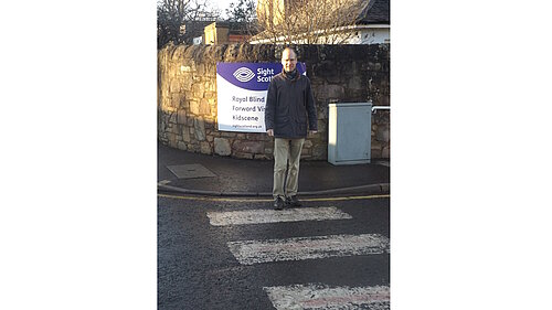 Neil standing on a zebra crossing