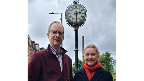 Councillor Neil Ross and Anna Aitken standing in front of the Morningside clock