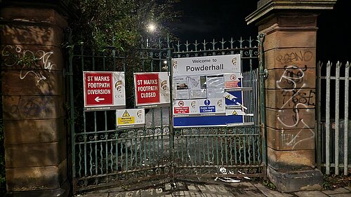 Closed gate at the path with signage