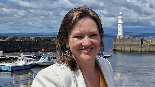 Sanne with Newhaven Harbour and Blue skies in the background